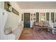 Front porch with a white bench, rocking chairs, and brick flooring at 1765 Holly Springs Ne Rd, Marietta, GA 30062