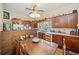 Eat-in kitchen with wood cabinets, a stone accent wall, and a farmhouse table at 1765 Holly Springs Ne Rd, Marietta, GA 30062