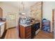 Country kitchen with wood cabinets, stone wall, and updated appliances at 1765 Holly Springs Ne Rd, Marietta, GA 30062