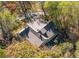 Aerial view of house nestled in a wooded area, showcasing its roofline and landscaping at 1765 Holly Springs Ne Rd, Marietta, GA 30062