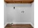 Laundry room with built-in shelving and vinyl flooring at 8291 Highway 5, Whitesburg, GA 30185