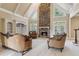 Two-story living room with a stone fireplace and built-in shelving at 4385 Hamilton Mill Rd, Buford, GA 30518