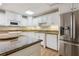 Granite kitchen island and stainless steel appliances in basement kitchen at 4385 Hamilton Mill Rd, Buford, GA 30518