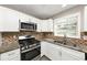 Updated kitchen featuring stainless steel appliances and granite countertops at 214 Kensington Trce, Stockbridge, GA 30281