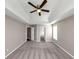 Spacious bedroom with tray ceiling, carpet, and en-suite bathroom access at 214 Kensington Trce, Stockbridge, GA 30281