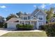 Two-story home with light blue siding and landscaping at 214 Kensington Trce, Stockbridge, GA 30281