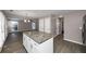 Kitchen island with granite countertop, white cabinets, and hardwood floors at 214 Kensington Trce, Stockbridge, GA 30281