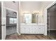 Double vanity bathroom with ample storage and wood-look floors at 214 Kensington Trce, Stockbridge, GA 30281