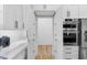 Walk-in pantry with white cabinetry and wood flooring at 156 Martha Ne Ave, Atlanta, GA 30317