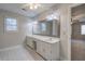 Double vanity bathroom with a large mirror and updated flooring at 2864 Holly Oaks Dr, Marietta, GA 30062