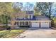 Two-story house with a brick facade, attached two-car garage, and landscaping at 2864 Holly Oaks Dr, Marietta, GA 30062