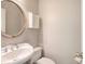Small powder room with pedestal sink and decorative mirror at 2864 Holly Oaks Dr, Marietta, GA 30062