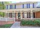 Charming front porch with white railings and brick columns at 2864 Holly Oaks Dr, Marietta, GA 30062