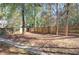 Fenced backyard with mature trees and side yard access at 2864 Holly Oaks Dr, Marietta, GA 30062