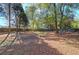 Large backyard with mature trees and wooden fence at 2864 Holly Oaks Dr, Marietta, GA 30062