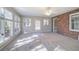 Bright sunroom with brick wall, carpet flooring, and multiple windows at 2864 Holly Oaks Dr, Marietta, GA 30062
