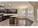 Eat-in kitchen featuring dark wood cabinets and hardwood floors at 3419 Woodward Down Trl, Buford, GA 30519