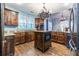 Eat-in kitchen with an island, granite countertops, and dark wood cabinets at 1391 Arbor Hill Ct, Lawrenceville, GA 30045