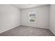 Bright bedroom with gray carpet and a window offering natural light at 102 Rocky Branch Way, Villa Rica, GA 30180