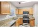 Kitchen features granite countertops and stainless steel appliances at 102 Rocky Branch Way, Villa Rica, GA 30180