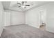Primary bedroom with ceiling fan and en-suite bathroom at 102 Rocky Branch Way, Villa Rica, GA 30180