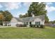 Attractive house exterior with a large yard and landscaping at 102 Rocky Branch Way, Villa Rica, GA 30180