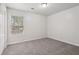 Spacious bedroom with gray carpeting and a window with blinds at 102 Rocky Branch Way, Villa Rica, GA 30180