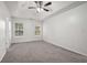 Spacious bedroom with ceiling fan and gray carpeting at 102 Rocky Branch Way, Villa Rica, GA 30180