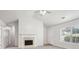 Bright living room featuring a fireplace, vaulted ceiling and neutral decor at 102 Rocky Branch Way, Villa Rica, GA 30180