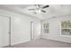 Primary bedroom with ceiling fan and en-suite bathroom at 102 Rocky Branch Way, Villa Rica, GA 30180