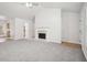 Open concept living room with a fireplace and view into kitchen area at 102 Rocky Branch Way, Villa Rica, GA 30180