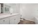 Bright bathroom features a vanity with white cabinets, a toilet, and a bathtub at 102 Rocky Branch Way, Villa Rica, GA 30180