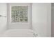 Relaxing bathroom with a soaking tub and window, offering natural light at 102 Rocky Branch Way, Villa Rica, GA 30180