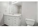 Clean bathroom with white vanity, toilet and a large mirror at 102 Rocky Branch Way, Villa Rica, GA 30180