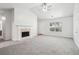 Open living room with vaulted ceiling, fireplace and neutral color scheme at 102 Rocky Branch Way, Villa Rica, GA 30180