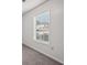 Bright bedroom with a large window and neutral walls at 102 Rocky Branch Way, Villa Rica, GA 30180
