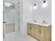 Double vanity bathroom with light wood cabinets and gold fixtures at 467 Concord Sw Rd, Smyrna, GA 30082