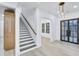 Bright entryway with modern staircase, wood floors, and stylish front door at 467 Concord Sw Rd, Smyrna, GA 30082