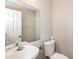 Small bathroom with a sink, toilet, and large mirror at 611 Shadow Valley Ct, Lithonia, GA 30058