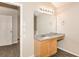 Bathroom vanity with granite countertop, wooden cabinetry, and large mirror at 611 Shadow Valley Ct, Lithonia, GA 30058