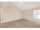 Large, empty bedroom with neutral walls, carpeting, and ample natural light at 611 Shadow Valley Ct, Lithonia, GA 30058
