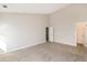 Open bedroom with neutral walls, plush carpeting, and access to another room at 611 Shadow Valley Ct, Lithonia, GA 30058