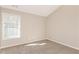 Empty bedroom with neutral walls, carpet, and a large window at 611 Shadow Valley Ct, Lithonia, GA 30058