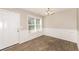 Dining room with wainscoting, wood-look tile floor, and modern light fixture at 611 Shadow Valley Ct, Lithonia, GA 30058