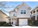 Charming two-story home with a brick and siding exterior, attached garage, and inviting front porch at 611 Shadow Valley Ct, Lithonia, GA 30058