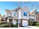Two-story home with brick and siding exterior, attached garage, and a welcoming walkway at 611 Shadow Valley Ct, Lithonia, GA 30058