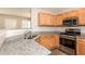 Modern kitchen with granite countertops, stainless steel appliances, and ample cabinet space at 611 Shadow Valley Ct, Lithonia, GA 30058