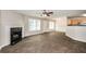 Living room with a cozy fireplace, wood-look tile floors, and ample natural light at 611 Shadow Valley Ct, Lithonia, GA 30058