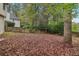 Large backyard with trees and wooden fence at 3450 Lookout Trce, Powder Springs, GA 30127