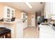 Kitchen with breakfast bar, white cabinets, and tile flooring at 210 Huiet Dr, Mcdonough, GA 30252